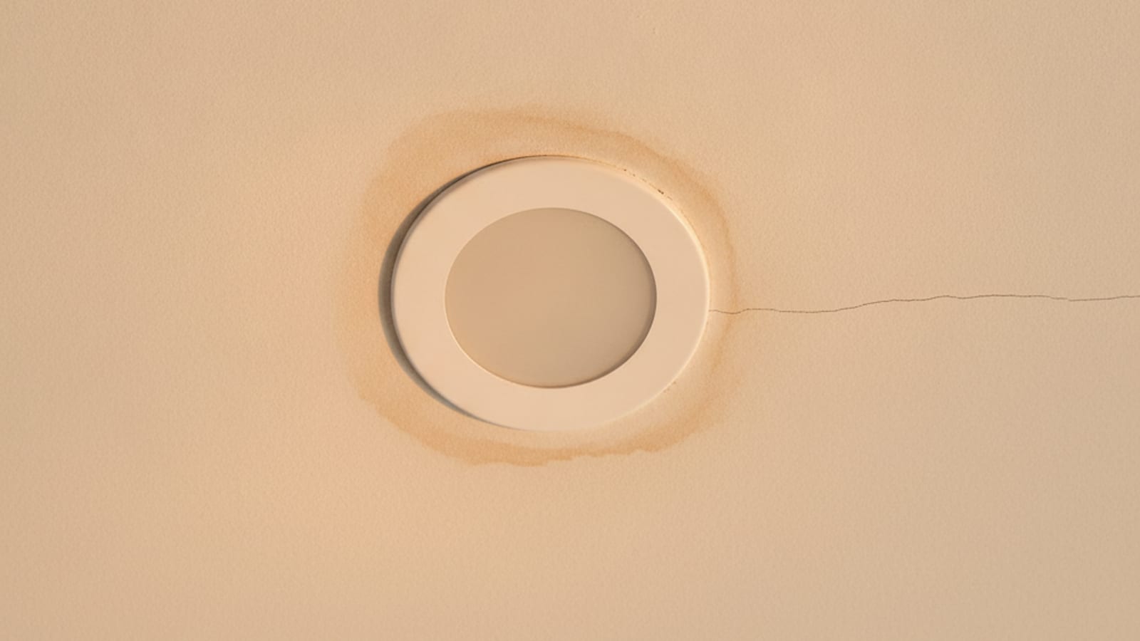 Close-up of solar tube flashing at the roofline on an Austin shingle roof showing sealed edges